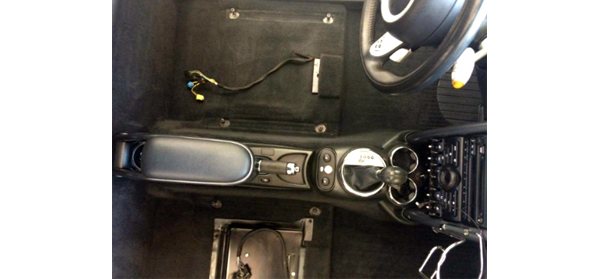 Detailed engine compartment of a car photographed from above with the hood open.